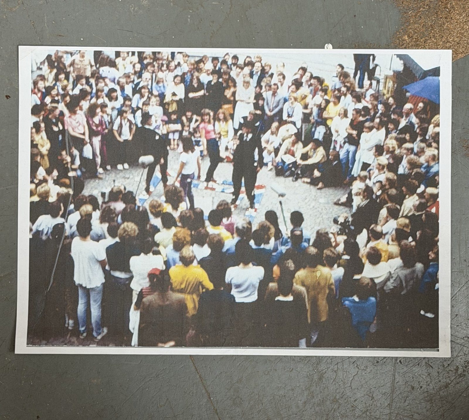 A large crowd gathered outdoors around a performance